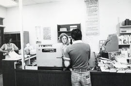 Photograph of Carmel McCloud helping a customer