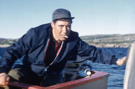 Photograph of George Koneak on a boat in Fort Chimo, Quebec