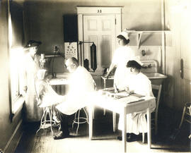 Photograph of Dr. J.A.M. Hemmeon with child patient