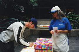 Photograph of Tina Usmiani assisting a patron at the Killam Web Café