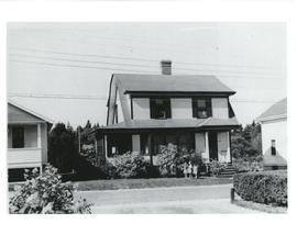 Photograph of three children, including Tommy and Frances Raddall, in front of the Raddall house ...