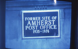 Photograph of a plaque reading "former site of Amherst post office 1935-1976"