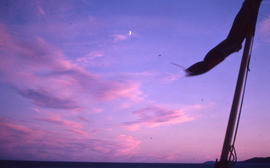 Photograph of the moon and a sunset taken from a boat off the coast of Newfoundland and Labrador
