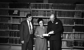 Photograph of three unidentified people in the law library