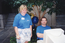 Photograph of Sandra Dwyer and another staff member working at the Killam Web Café