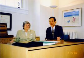 Photograph of Elisabeth Mann Borgese and a man at her desk