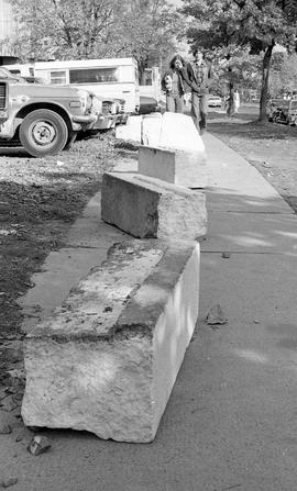 Photograph of large concrete blocks sitting on a sidewalk