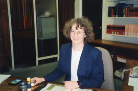 Photograph of librarian Karen Smith at her desk in the Killam Memorial Library