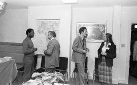 Photograph of four unidentified people mingling at the opening of the Ocean Studies house