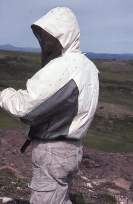 Photograph of Mike Crowell wearing insect repellent clothing near Voisey's Bay, Newfoundland and ...