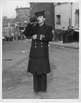 Photograph of a naval reserve lieutenant drinking from a bottle in downtown Halifax in the afterm...