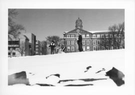Photograph of people skiing next to the Henry Hicks Arts & Administration Building