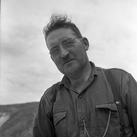 Photograph of an unidentified man wearing glasses