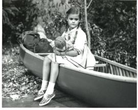 Photograph of six-year-old actress Charity Haines as "Emmy Quarrender" sitting on a canoe on the ...