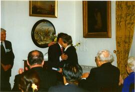 Photograph of Elisabeth Mann Borgese hugging an unidentified man
