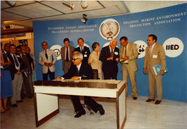 Photograph of a signing ceremony at a Hellenic Marine Environment Protection Association (HELMEPA...