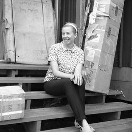 Photograph of Doreen Wynne sitting on a step in Wakeham Bay, Quebec