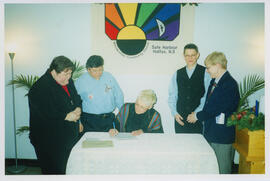Photograph of Dr. Brenda Hattie signing marriage certificate