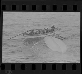 Photographic negative of a lifeboat with crew from the Mackay-Bennett investigating an overturned...