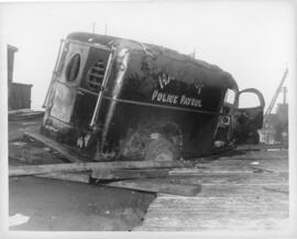 Photograph of a police van set afire and nearly run off the waterfront dock during the Halifax VE...