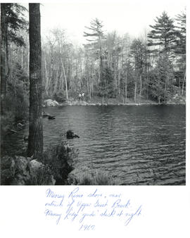 Photograph of two men hiking on the opposite shore of the Mersey River, near the entrance of Uppe...