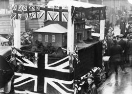 Photograph of a parade float bearing a model of the original Dalhousie College conveying the buil...