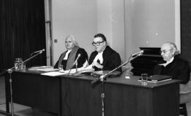 Photograph of three unidentified people at a law award presentation