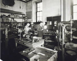 Photograph of two men working in a shop in the Science Building