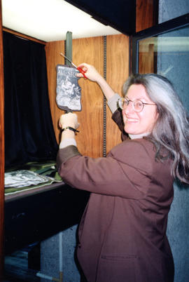 Photograph of Tina Usmiani creating a display on the fifth floor of the Killam Memorial Library