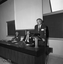 Photograph of an unidentified person speaking at the front of a classroom