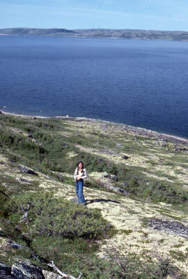 Photograph of an unidentified person standing on Long Island, near Postville, Newfoundland and La...