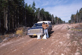 Photograph of Bill Freedman leaning against a truck at the Aylesford Lake site, central Nova Scotia