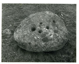 Photograph of a perforated stone at the Molega mines
