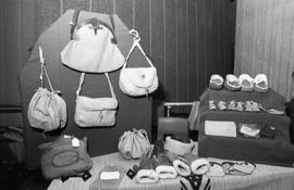 Photograph of a stand selling leather goods at a craft market
