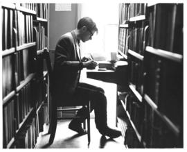 Photograph of a student working at a desk in the Macdonald library reading room