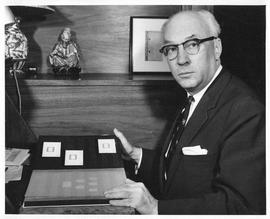 Photograph of Henry Hicks with a stamp collection