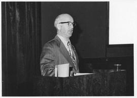 Photograph of an unidentified person speaking at a Canadian Postal Service meeting