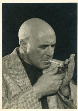Portrait of Thomas Head Raddall lighting a cigarette