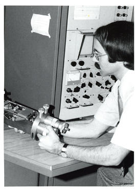 Photograph of individual holding a machine