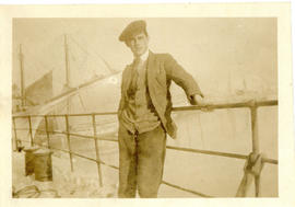 Photograph of Thomas Head Raddall on the quarter deck of the S.S. Watuka at St. John's, Newfoundland
