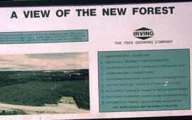 Photograph of an Irving plantation sign with panorama image and legend, northern New Brunswick