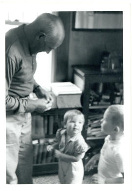 Photograph of Thomas Head Raddall in his study with his granddaughter, Deborah ("Pinkie"), and Da...