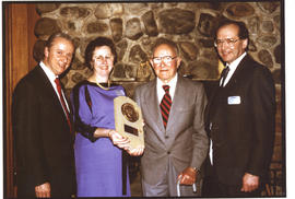 Photograph of Thomas Head Raddall being presented with the commemorative T.H. Raddall Prize plaque