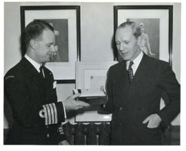 Photograph of Captain Harry DeWolfe, R.C.N. making a farewell presentation to Angus L. Macdonald