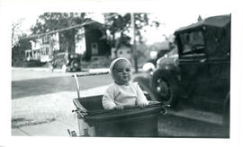 Photograph of Tommy Raddall, Jr. in a pram, aged 14 months