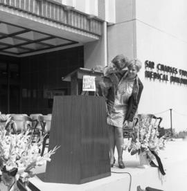 Photograph of an podium in front of the Tupper Building