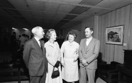 Photograph of four unidentified people at the presentation of a painting of Chester Stewart