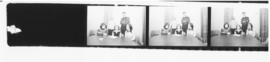 Contact sheet of photographs of unidentified people sitting at a table