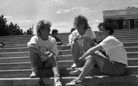 Photograph of students sitting on the steps by the Killam Library