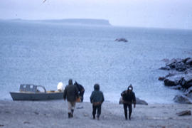 Photograph of four people near the shore in George River, Quebec